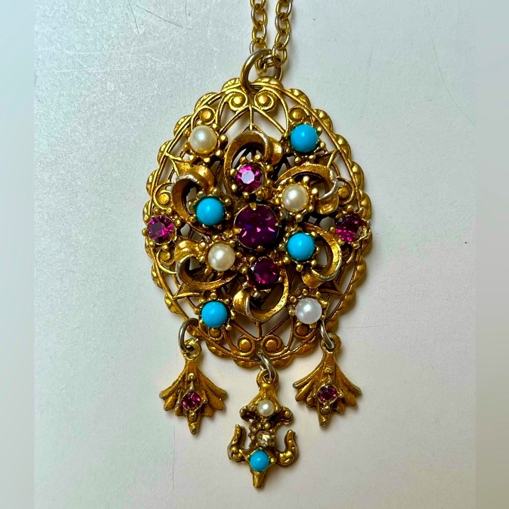 Goldtone necklace with turquoise,pearl and amethyst color stones.